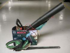 A Bosch corded garden vacuum, in box, and an electric hedge trimmer.