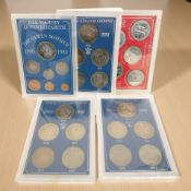 Five sets of United Kingdom commemorative coin sets including Crowns, Isle of Man Millenium set,
