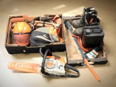 A Stihl MS211 petrol chainsaw, a pair of Stihl boots, a hard hat, other work clothing and equipment.
