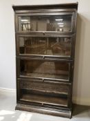 An early 20th century glazed oak four height stacking bookcase in the style of Globe Wernicke,