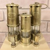 Three Lamp & Limelight brass miner's lamps, and two further miniature examples.