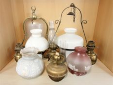 A group of antique oil lamps.