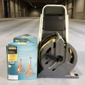 A folding step, a hose pipe on reel and two Halfords two tonne axle stands in boxes.