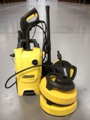 A Karcher K4 compact pressure washer with attachments.