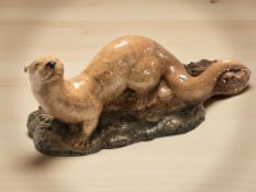 A ceramic figure of a weasel, length 40 cm.