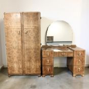 A 1950's burr walnut three piece bedroom suite comprising of a double door wardrobe with inner