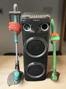 A Goodmans 500W party speaker model 349128, and two electric garden strimmers.
