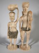 A pair of carved wooden figures of native fishermen, height 53 cm.