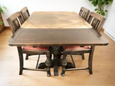 An early 20th century oak pull out extending dining table, with two leaves,