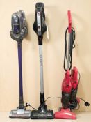 A Hoover stick vacuum cleaner, plus three others.