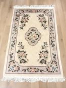 A Chinese floral rug on cream ground,
