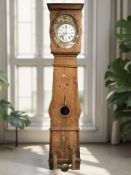 A 19th century French pine long case clock, with pendulum and two weights, height 224 cm.