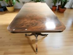 A reproduction inlaid mahogany twin pedestal extending dining table, with leaf,