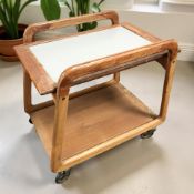 A 20th century teak two tier trolley on castors, length 70 cm.