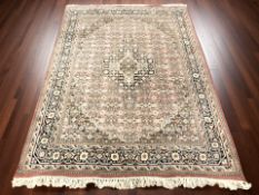 A Tabriz rug, 251 cm x 175 cm.