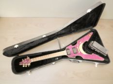 A Tanglewood flying V-shaped electric guitar, with purple body, brass fittings and twin pickups,