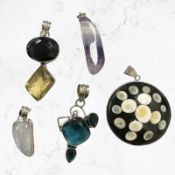 Five Continental white metal / silver mounted pendants,