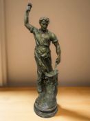 A patinated spelter figure of a blacksmith, height 69 cm.