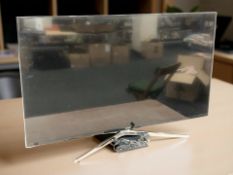 A Samsung 47 inch LCD TV with lead and remote