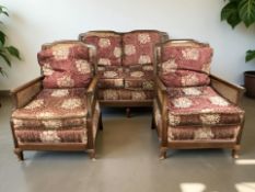 A 20th century walnut three piece bergere lounge suite, with caned arm and back rests,