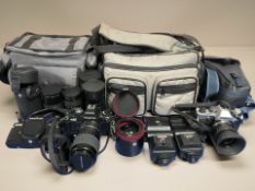 An Olympus OM20 camera, a Praktica BX20 camera, various lenses, flashes, etc.