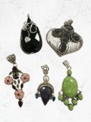 Five Continental white metal / silver mounted pendants, some parts stamped '925'.