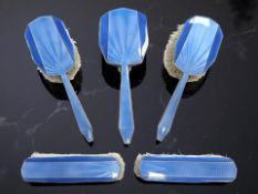 An Art Deco five-piece silver and blue guilloché enamel dressing table set, Reid & Sons,