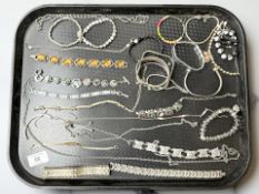 A group of costume jewellery, bracelets, chains,