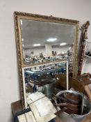 A reproduction gilt and bevelled mirror, 102 cm x 87 cm, together with another similar.