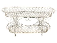 A painted wrought metal two tier planter,