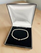 A cultured pearl necklace with yellow gold clasp,