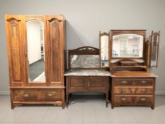 An Art Nouveau walnut three drawer mirror backed dressing table,