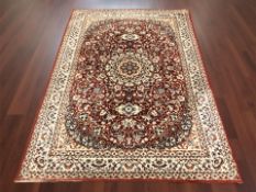 A machine made rug of Iranian design,