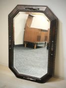 An Edwardian oak octagonal bevelled mirror, width 83 cm.
