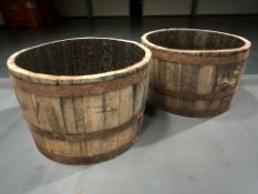 A pair of coopered oak barrel planters, diameter 65 cm.