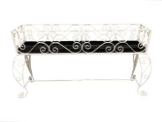 A painted wrought metal planter, 135 cm x 35 cm x 75 cm.
