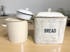 An enameled bread bin, width 40 cm, a further cylindrical bin and another enameled dish.