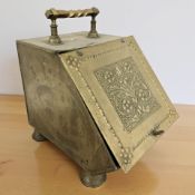 An Arts and Crafts brass coal receiver.