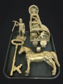 A brass mining model, a further figure of a miner, a large key, a horse, and three graduated owls.