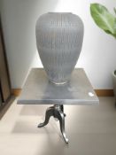 An aluminium square pedestal table, width 63 cm, together with a painted ceramic plant pot.