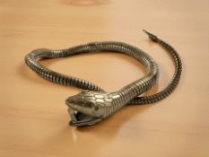 A Victorian brass cigar cutter in the form of a reticulated snake, length approximately 40 cm.