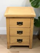 A modern oak three drawer bedside chest, width 49 cm.