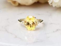 A 9ct yellow gold citrine ring set with diamond shoulders, size M.