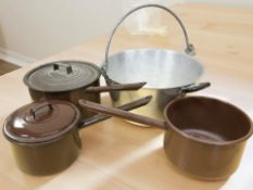 An aluminium jam pan and a graduated set of enameled cooking pans.