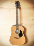A Boston BN200 acoustic guitar.
