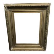An antique gilt gesso picture frame, overall 103 cm x 83 cm, inner measurement 56 cm x 74 cm.