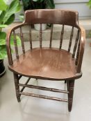 A stained oak spindle back low armchair,
