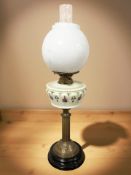 A Victorian brass oil lamp, stamped Bamford, England, with hand painted opaque glass reservoir,
