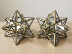 A pair of glazed metal star light shades, diameter 23 cm.