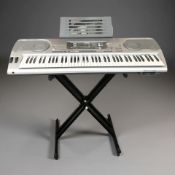 A Casio WK-3500 digital keyboard, with box and folding stand.